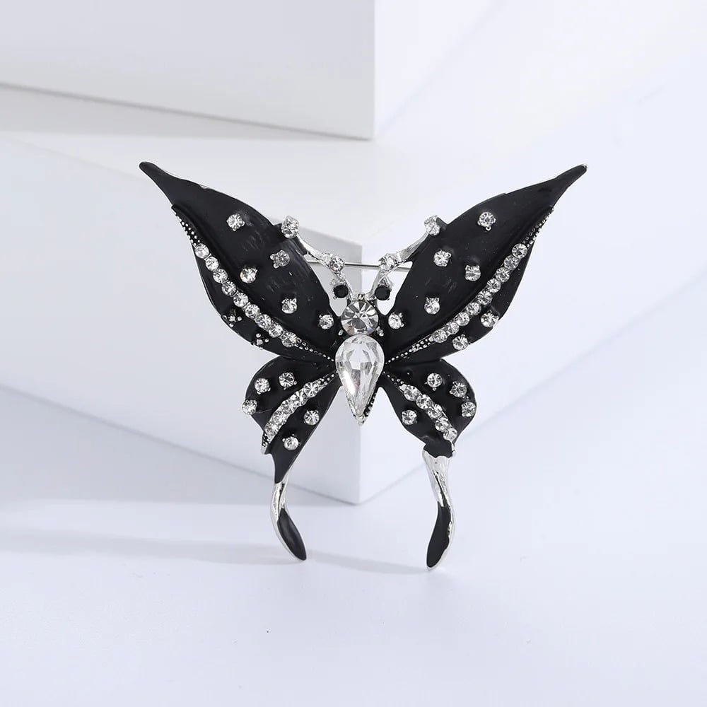 Brosa Leona, neagra, cu montura argintie, in forma de fluture
