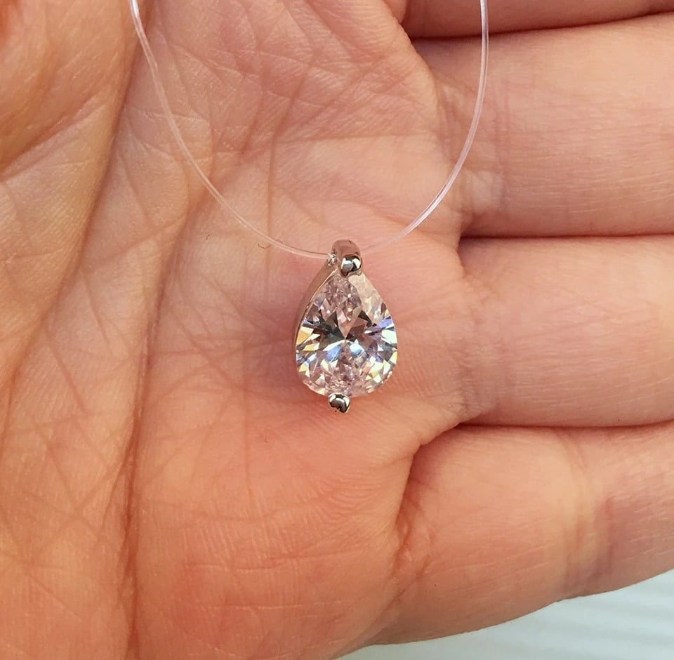 Elsi necklace, with a transparent string and a silver tear-shaped pendant